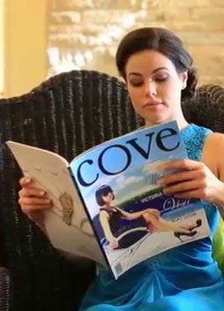 Woman Reading Cove Magazine — Cove Magazine In Sanctuary Cove, QLD